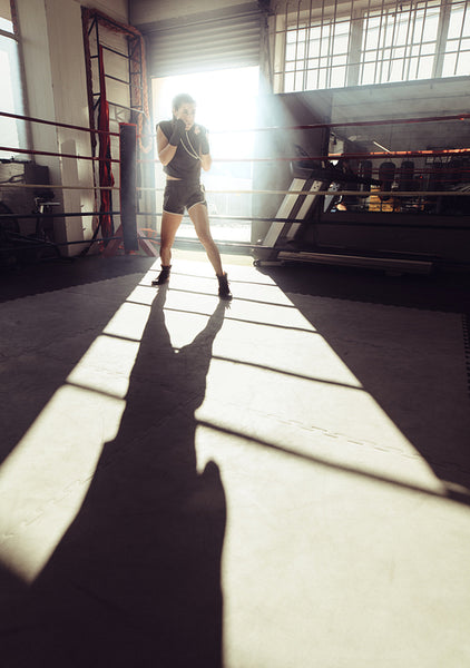 Female boxer training inside a boxing ring
