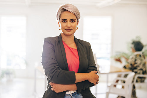 Confident businesswoman standing in a creative office