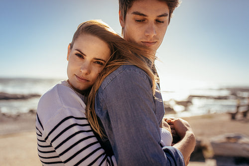 Couple standing together at a beach