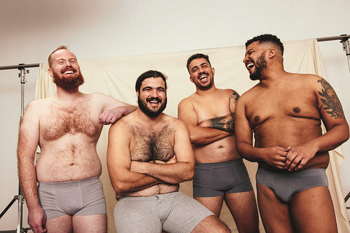 Cheerful laughter among body positive men
