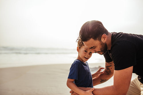 Young man with his son at the beach