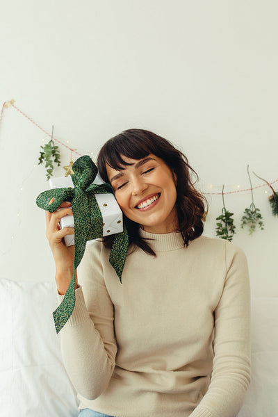 Portrait of happy woman holding a christmas gift