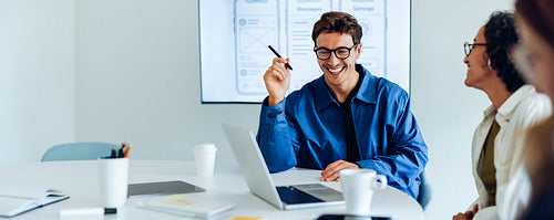 Male and female UX designers discuss ideas