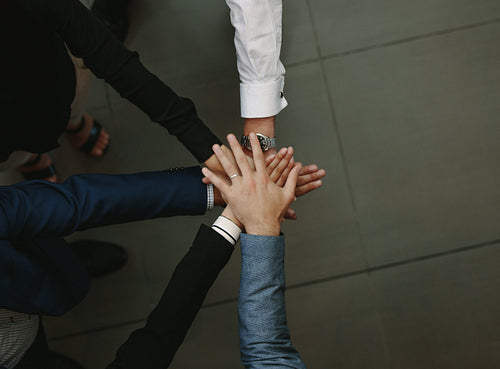 Business group putting hands together