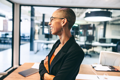 Successful female entrepreneur smiling cheerfully in an office