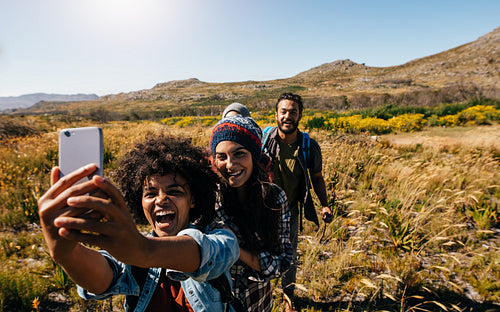 Group of friends on country hike taking selfie