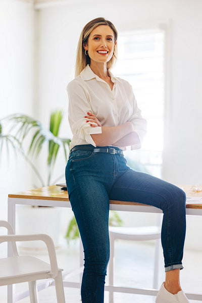 Female entrepreneur smiling at the camera in a modern office