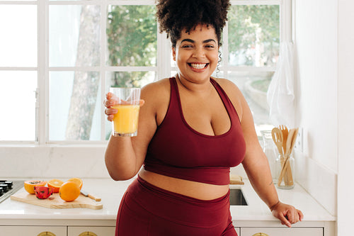 Healthy woman holding glass of juice