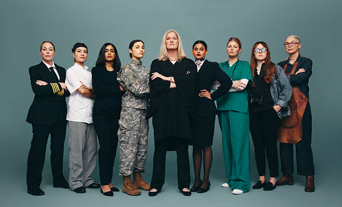 Group of diverse female professionals standing together in a stu