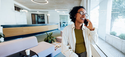 Woman talking on the phone in lobby