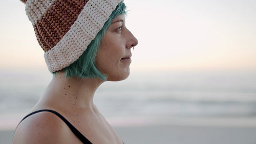 Woman with knitted hat on beach
