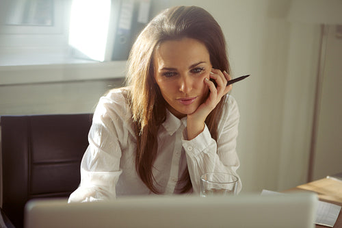 Young businesswoman using laptop in home office