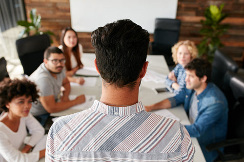 Man giving business presentation to colleagues in conference room