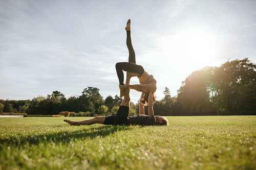 Healthy young couple doing acroyoga