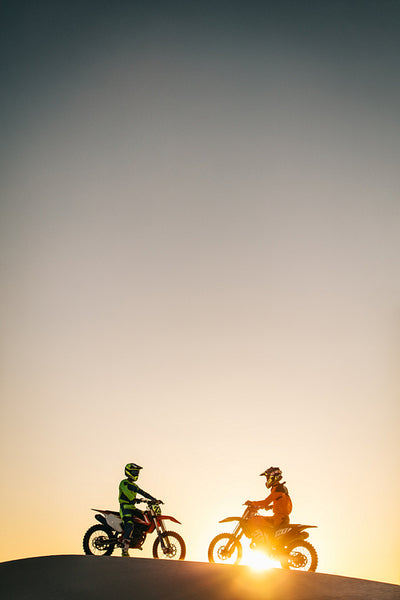 Motocross bikers on their bikes in a desert