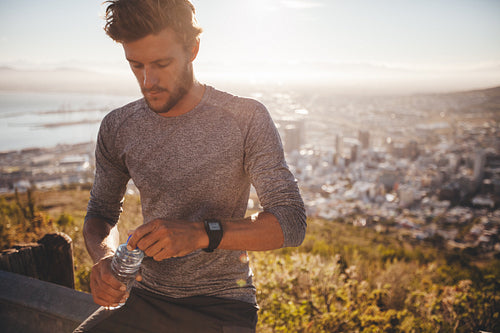 Runner taking break and drinking water