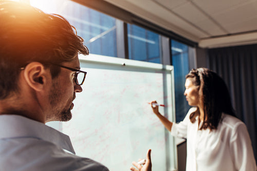 Business colleagues discussing ideas in office.