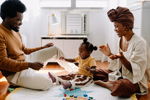 Family playtime at home with baby and toddler