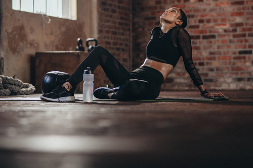 Tired woman taking rest after intense training