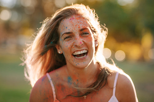 Portrait of a woman enjoying holi