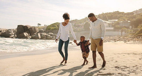 African family on beach walk