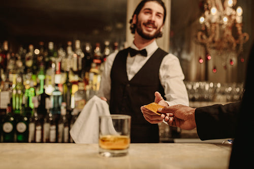 Man making a cashless payment at nightclub bar