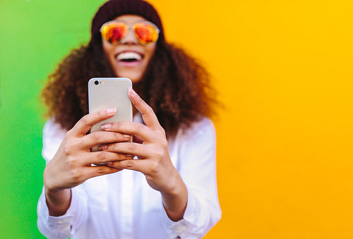 Curly haired african girl taking a selfie