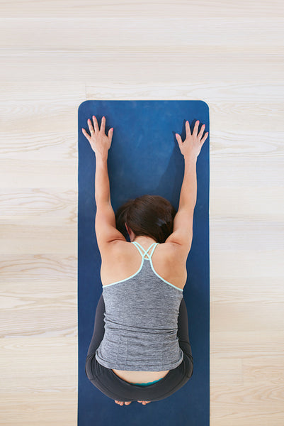 Woman practicing yoga at gym
