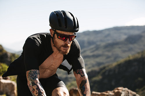 Cyclist riding bike on hot summer day