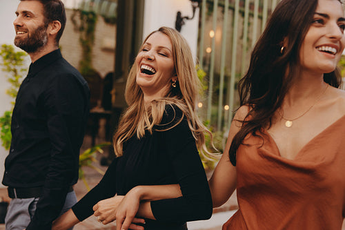 Happy group of friends arriving at a luxury hotel