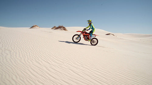 Fast motorcyclist jumping obstacles in a desert