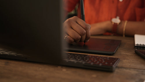 Female graphic designer drawing with a stylus open