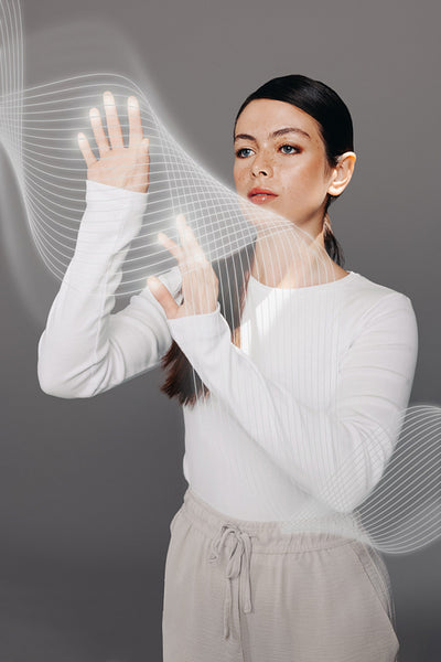 Interacting with cyberspace: Woman touching a screen interface in a studio