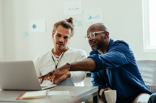 Business colleagues collaborating and reviewing feedback during a brainstorming session
