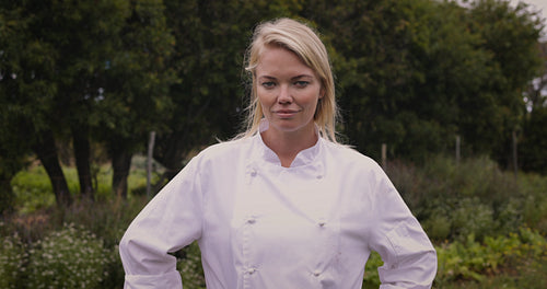 Confident female chef standing on an organic farm
