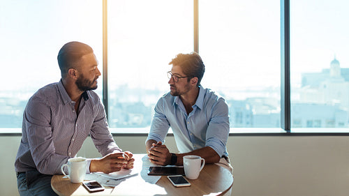 Business investors discussing business over a cup of coffee.