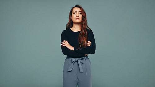 Independent young woman standing in a studio