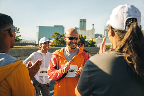 Marathon participants celebrating with clapping after achievement