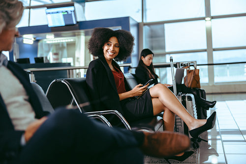 People waiting at airport departure area