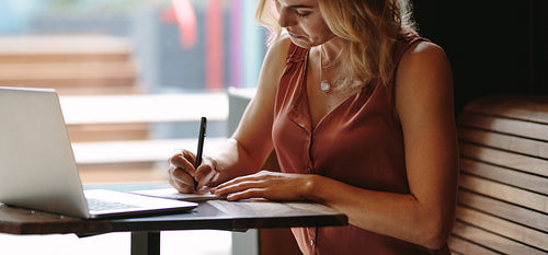 Woman doing work sitting in a coffee shop