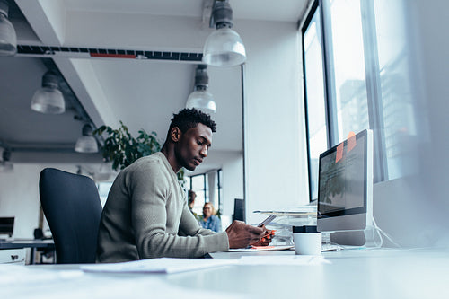 Male executive using mobile phone in office