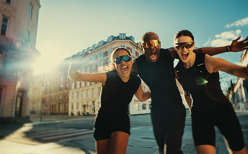 After training, running friends keep socializing outdoors on a city street