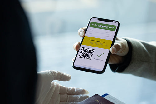 Tourist check in showing immunity e-passport to ground staff