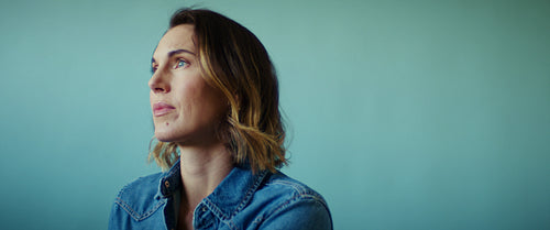 Confident business professional smiles at the camera in a medium shot