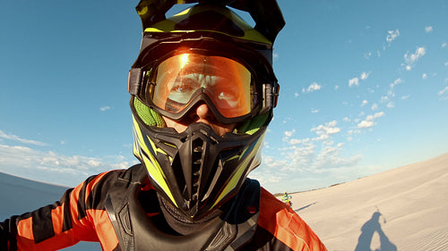 Motocross racer riding in a desert