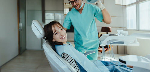 Young girl sits fearlessly in a dental chair for a checkup