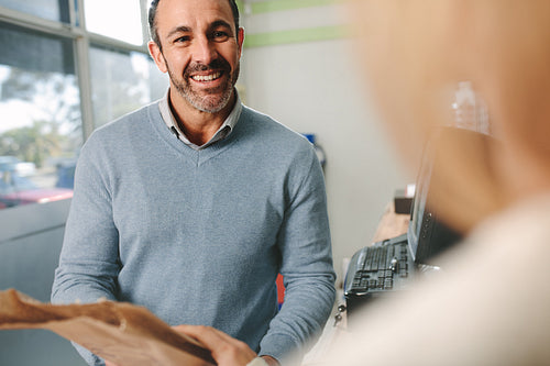 Pharmacist dealing with customer at pharmacy