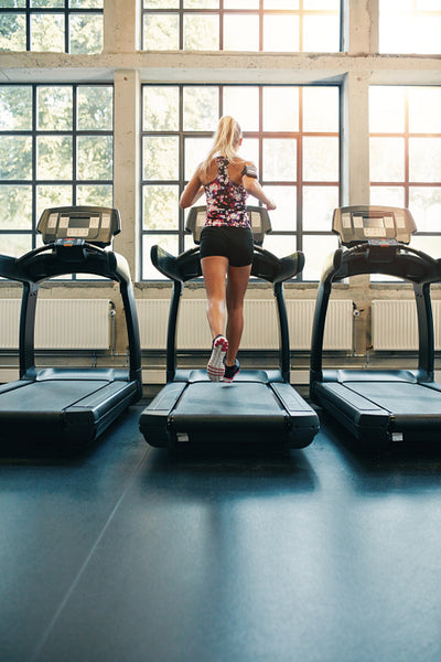 Fitness woman running on treadmill