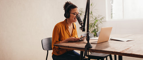 Woman recording a podcast from home studio