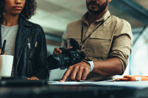 Photographer discussing ideas of photo shoot with a model